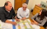 Transportation Minister Miri Regev (right) sits with Israel Railways CEO Michael Maixner (left) and Moshe Shimoni, chairman of the Israel Railways board of directors, in Jerusalem, January 11, 2023. (Transportation Minister's Office)