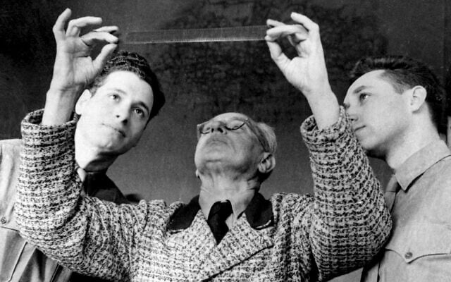 Hitler's photographer Heinrich Hoffmann (center) assisted Stuart Schulberg (right) and others of the OSS Field Film Photographic Branch - War Crimes Unit examine footage after his capture by Allied forces. (Courtesy of Kino Lorber)