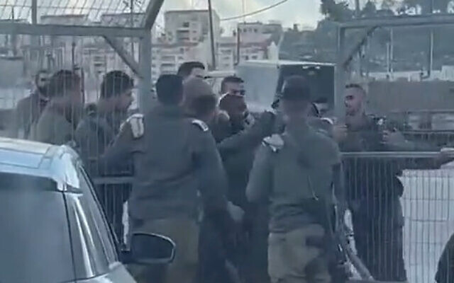 An altercation between soldiers is seen at the entrance of the Harsina military outpost, near the West Bank city of Hebron, January 30, 2023. (Screenshot: used in accordance with Clause 27a of the Copyright Law) An altercation between soldiers is seen at the entrance of the Harsina military outpost, near the West Bank city of Hebron, January 30, 2023. (Screenshot: used in accordance with Clause 27a of the Copyright Law)