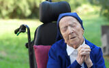 Sister Andre, Lucile Randon in the registry of birth, prays in a wheelchair, on the eve of her 117th birthday, February 10, 2021. (Nicolas Tucat/AFP)