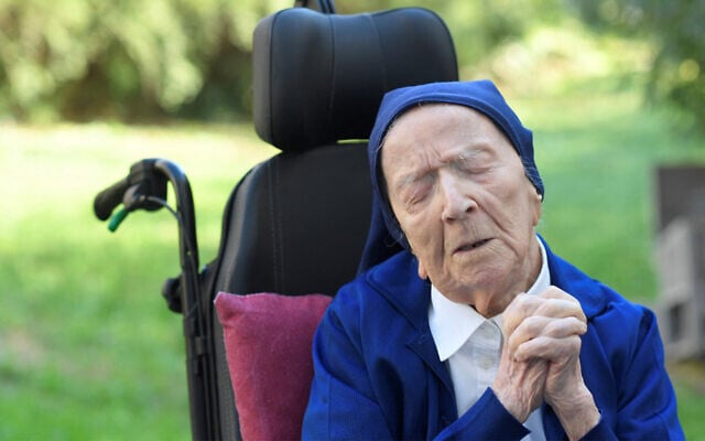 Sister Andre, Lucile Randon in the registry of birth, prays in a wheelchair, on the eve of her 117th birthday, February 10, 2021. (Nicolas Tucat/AFP) Sister Andre, Lucile Randon in the registry of birth, prays in a wheelchair, on the eve of her 117th birthday, February 10, 2021. (Nicolas Tucat/AFP)