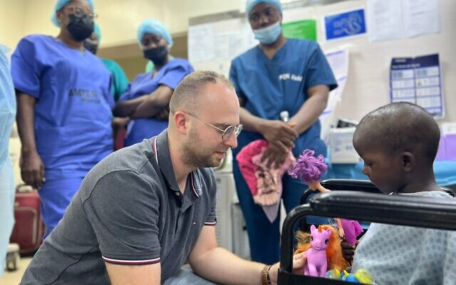 Dr. Mattan Arazi, ophthalmology resident at Sheba medical Center, consulting with a child in Nigeria as part of a humanitarian mission on January 10, 2023. (Courtesy: Sheba Medical Center) Dr. Mattan Arazi, ophthalmology resident at Sheba medical Center, consulting with a child in Nigeria as part of a humanitarian mission on January 10, 2023. (Courtesy: Sheba Medical Center)
