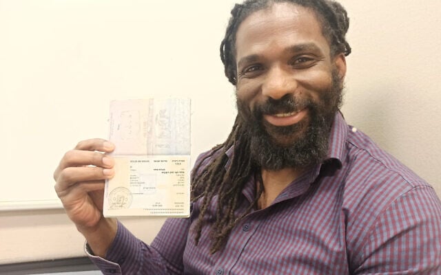 David Ben Moshe holds his newly received immigrant visa in the Population Authority on January 12, 2023. (Courtesy/David Ben Moshe)