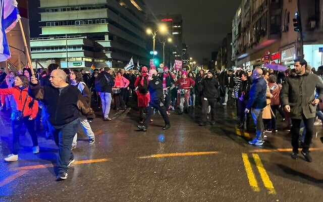 Protesters march down Ibn Gabirol Street in Tel Aviv, during an anti-government protest, on January 14, 2023. (Naomi Lanzkron/Times of Israel)