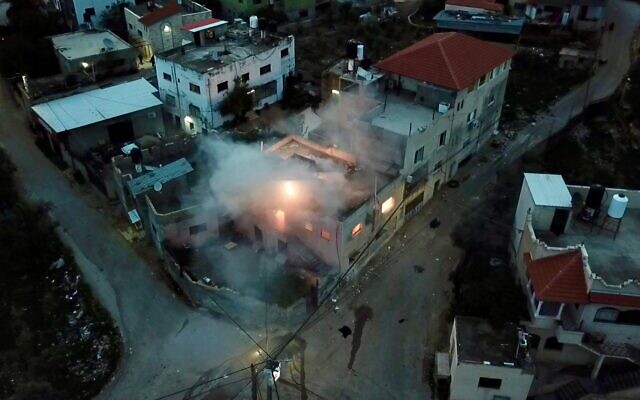 Smoke rises after Israeli troops demolish the home of a Palestinian gunman who killed an officer along the West Bank security barrier, in the village of Kafr Dan on January 2, 2023. (Israel Defense Forces) Smoke rises after Israeli troops demolish the home of a Palestinian gunman who killed an officer along the West Bank security barrier, in the village of Kafr Dan on January 2, 2023. (Israel Defense Forces)