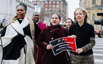 From left to right: Rev. Traci Blackmon, Maharat Rori Picker Neiss and Americans United for Separation of Church & State CEO Rachel Laser march to the Civil Courts building in St. Louis. (Courtesy of Americans United for Separation of Church & State via JTA)