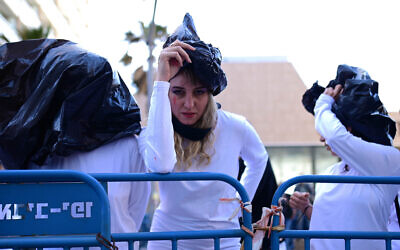 Activists protest to raise awareness of sexual violence against Ukrainian women and children in the Russian invasion of Ukraine, outside the Russian Embassy in Tel Aviv, on April 20, 2022. (Tomer Neuberg/Flash90)