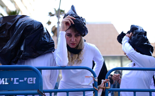 Activists protest to raise awareness of sexual violence against Ukrainian women and children in the Russian invasion of Ukraine, outside the Russian Embassy in Tel Aviv, on April 20, 2022. (Tomer Neuberg/Flash90)