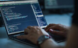 Illustrative: A man types on a computer keyboard as coding language is seen on the screen (gorodenkoff; iStock by Getty Images)