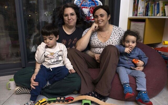 Yael Rashlin (R) a transgender woman, poses for a photo with her partner Hadar and and their children Yarden and Hillel, at their home in the town of Tzur Hadassah in central Israel, on December 1, 2022. (MENAHEM KAHANA / AFP) Yael Rashlin (R) a transgender woman, poses for a photo with her partner Hadar and and their children Yarden and Hillel, at their home in the town of Tzur Hadassah in central Israel, on December 1, 2022. (MENAHEM KAHANA / AFP)