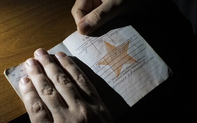 Hiding Russian army reservist Dmitry, whose name has been changed for security reasons, shows his army booklet during an AFP interview at an undisclosed location in Russia in 2023. (Romain COLAS / AFP) Hiding Russian army reservist Dmitry, whose name has been changed for security reasons, shows his army booklet during an AFP interview at an undisclosed location in Russia in 2023. (Romain COLAS / AFP)