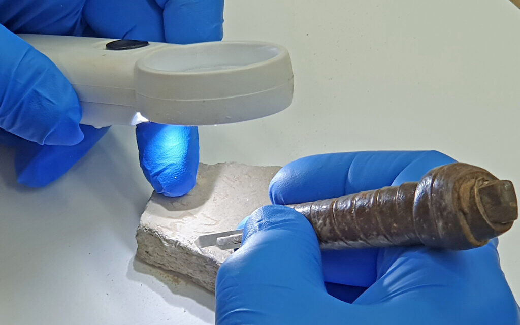 Experts work to examine and preserve the Darius I potsherd discovered in Tel Lachish in December 2022. The potsherd was believed to be the first written evidence of Persian king Darius the Great discovered in Israel, but later found to not be authentic. (Saar Ganon/IAA)