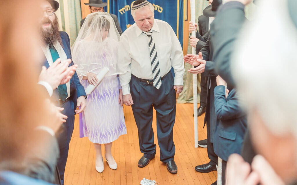 A couple prepares to step on a glass, a symbol in Jewish weddings, after their Jewish ceremony in Boston, February 7, 2023. (Igor Klimov via JTA) A couple prepares to step on a glass, a symbol in Jewish weddings, after their Jewish ceremony in Boston, February 7, 2023. (Igor Klimov via JTA)