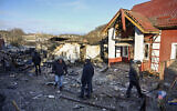 Local residents inspect debris following a barrage of drone strikes from Russia in Stari Bezradychi village, Kyiv region, on December 19, 2022. (Sergei Chuzavkov/AFP)