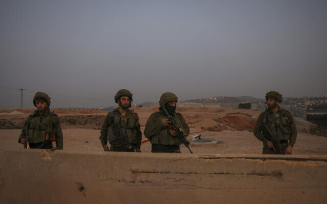 IDF soldiers patrol the main road in Huwara town in the West Bank, on February 27, 2023. (Ronaldo Schemidt/AFP) IDF soldiers patrol the main road in Huwara town in the West Bank, on February 27, 2023. (Ronaldo Schemidt/AFP)