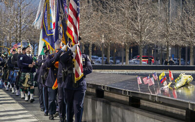 An honor guard, followed by bagpipers, pay their respects to victims of the 1993 bombing World Trade Center during a ceremony marking the 28th anniversary of the attack, in New York, February 26, 2021. (Mary Altaffer/AP)