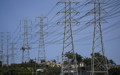 Illustrative: Power transmission towers stand near homes in Redondo Beach, California, September 7, 2022. (AP Photo/ Jae C. Hong)