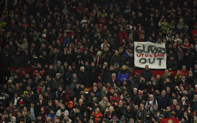 An anti-Glazer family banner is held up by members of the crowd before the English League Cup semifinal second leg soccer match between Manchester United and Nottingham Forest at Old Trafford in Manchester, England, Wednesday, February 1, 2023. (AP Photo/Dave Thompson) An anti-Glazer family banner is held up by members of the crowd before the English League Cup semifinal second leg soccer match between Manchester United and Nottingham Forest at Old Trafford in Manchester, England, Wednesday, February 1, 2023. (AP Photo/Dave Thompson)