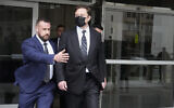 Elon Musk, center, leaves a federal courthouse in San Francisco, February 3, 2023. (AP Photo/Jeff Chiu)