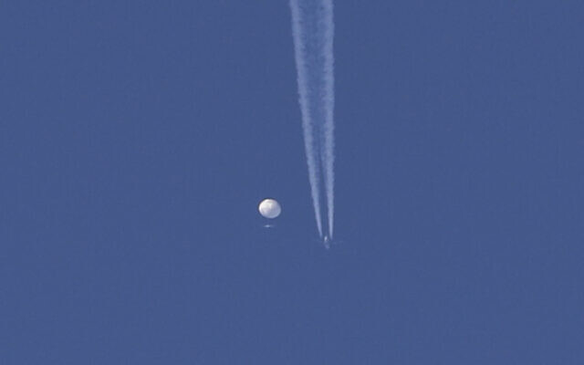 A large balloon drifts above the Kingstown, North Carolina area, with an airplane and its contrail seen below it. (Brian Branch via AP) A large balloon drifts above the Kingstown, North Carolina area, with an airplane and its contrail seen below it. (Brian Branch via AP)