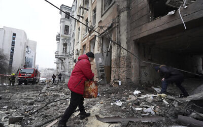 A person enters a residential building which was hit by a Russian rocket at the city center of Kharkiv, Ukraine, Sunday, Feb. 5, 2023. (AP/Andrii Marienko)