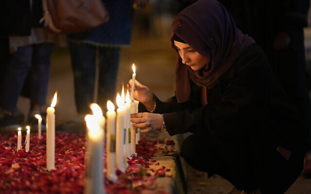 A woman light candles during a candle light vigil for the victims of earthquake in Syria and Turkey, in Islamabad, Pakistan, Monday, Feb. 6, 2023. (AP Photo/Anjum Naveed) A woman light candles during a candle light vigil for the victims of earthquake in Syria and Turkey, in Islamabad, Pakistan, Monday, Feb. 6, 2023. (AP Photo/Anjum Naveed)