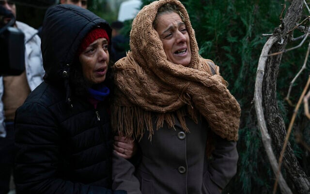 Women cry as they watch while the emergency teams search for people in the rubble of a destroyed building in Adana, Turkey, Monday, Feb. 6, 2023. (AP Photo/Khalil Hamra) Women cry as they watch while the emergency teams search for people in the rubble of a destroyed building in Adana, Turkey, Monday, Feb. 6, 2023. (AP Photo/Khalil Hamra)