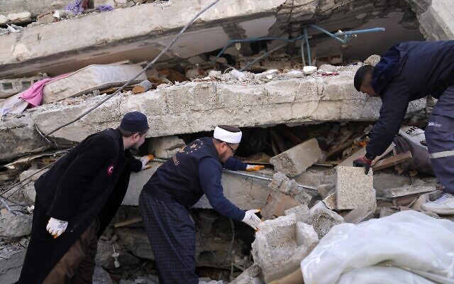People and emergency teams search for survivors in the rubble of a destroyed building, in Iskenderun town, southern Turkey, Tuesday, Feb. 7, 2023. (AP Photo/Hussein Malla) People and emergency teams search for survivors in the rubble of a destroyed building, in Iskenderun town, southern Turkey, Tuesday, Feb. 7, 2023. (AP Photo/Hussein Malla)