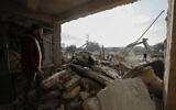 Rescue teams search through the wreckage of collapsed buildings after a devastating earthquake rocked Syria and Turkey, in Aleppo, Syria, February 7, 2023. (AP Photo/Omar Sanadiki, File)