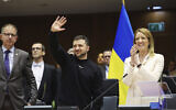 Ukraine's President Volodymyr Zelensky, center, gestures as European Parliament's President Roberta Metsola, right, applauds during an EU summit at the European Parliament in Brussels, Belgium, February 9, 2023. (AP Photo/Olivier Matthys)