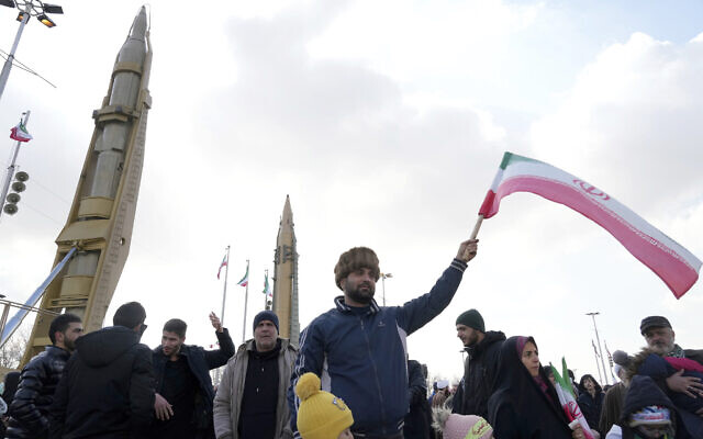 A man waves an Iranian flag as domestically built missiles are displayed in the background during the annual rally commemorating Iran's 1979 Islamic Revolution, in Tehran, Iran, February 11, 2023. (AP Photo/Vahid Salemi) A man waves an Iranian flag as domestically built missiles are displayed in the background during the annual rally commemorating Iran's 1979 Islamic Revolution, in Tehran, Iran, February 11, 2023. (AP Photo/Vahid Salemi)