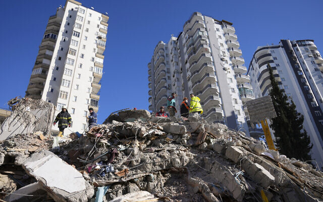 FILE - Emergency teams search for people in the rubble of a destroyed building in Adana, southern Turkey, February 7, 2023. (AP Photo/Hussein Malla, File)