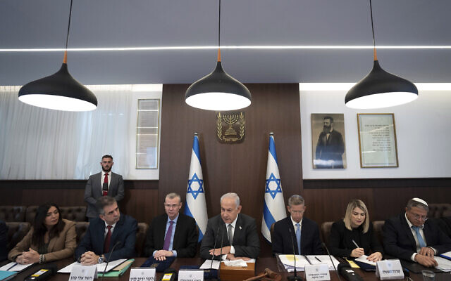 Prime Minister Benjamin Netanyahu, center, chairs the weekly cabinet meeting in Jerusalem, Feb.12, 2023. (AP Photo/Ohad Zwigenberg, Pool) Prime Minister Benjamin Netanyahu, center, chairs the weekly cabinet meeting in Jerusalem, Feb.12, 2023. (AP Photo/Ohad Zwigenberg, Pool)