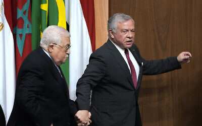 Palestinian Authority President Mahmoud Abbas, left, is accompanied by King Abdullah II of Jordan, during a conference at the Arab League headquarters in Cairo, Egypt, Sunday, Feb. 12, 2023. (AP Photo/Amr Nabil)