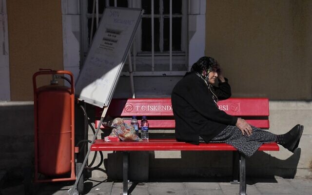 A woman sits on a bench of a train station in Iskenderun city, southern Turkey, February 14, 2023. (Hussein Malla/AP)