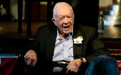 Former US president Jimmy Carter reacts, as his wife Rosalynn Carter speaks during a reception to celebrate their 75th wedding anniversary, July 10, 2021, in Plains, Georgia. (AP Photo/John Bazemore, Pool, File)