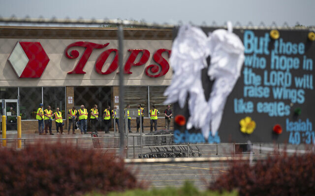 FILE - Investigators stand outside during a moment of silence for the victims of the Buffalo supermarket shooting outside the Tops Friendly Market on May 21, 2022, in Buffalo, New York. (AP Photo/Joshua Bessex, File) FILE - Investigators stand outside during a moment of silence for the victims of the Buffalo supermarket shooting outside the Tops Friendly Market on May 21, 2022, in Buffalo, New York. (AP Photo/Joshua Bessex, File)