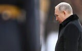 Russian President Vladimir Putin attends a wreath-laying ceremony at the Tomb of the Unknown Soldier, near the Kremlin Wall during the national celebrations of the 'Defender of the Fatherland Day' in Moscow, Russia, February 23, 2023. (Pavel Bednyakov, Sputnik, Kremlin Pool Photo via AP)