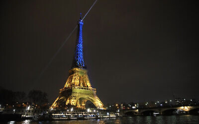 The Eiffel Tower is illuminated with the colors of Ukraine to mark the one-year anniversary of Russia's invasion of the country, in Paris, February 23, 2023. (AP Photo/Christophe Ena)