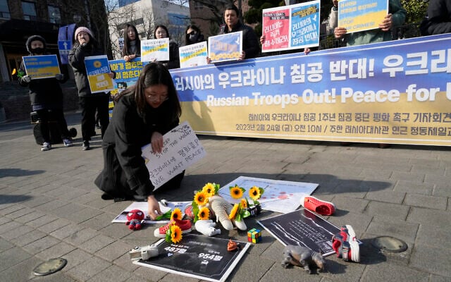 A protester places a flower to pay tribute to children killed in Russia's war against Ukraine during a rally to mark the one-year anniversary of Russia's invasion of Ukraine, near the Russian Embassy in Seoul, South Korea, February 24, 2023. (AP Photo/Ahn Young-joon) A protester places a flower to pay tribute to children killed in Russia's war against Ukraine during a rally to mark the one-year anniversary of Russia's invasion of Ukraine, near the Russian Embassy in Seoul, South Korea, February 24, 2023. (AP Photo/Ahn Young-joon)