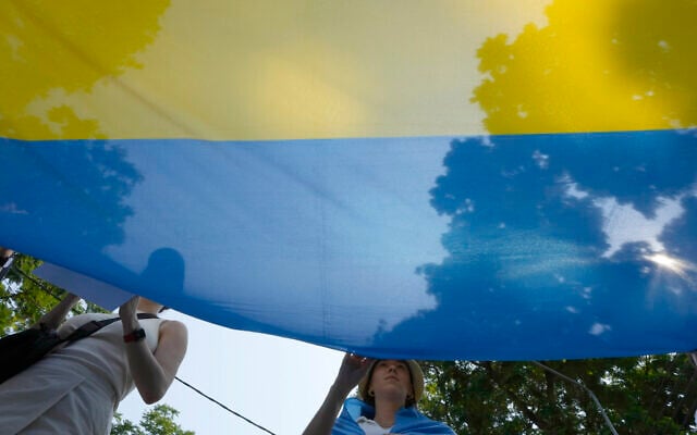 Ukrainian people living in Thailand hold Ukraine national flag during a rally to mark the one-year anniversary of Russia's invasion of Ukraine, in Bangkok, Thailand, February 24, 2023. (AP Photo/Salkchai Lalit) Ukrainian people living in Thailand hold Ukraine national flag during a rally to mark the one-year anniversary of Russia's invasion of Ukraine, in Bangkok, Thailand, February 24, 2023. (AP Photo/Salkchai Lalit)