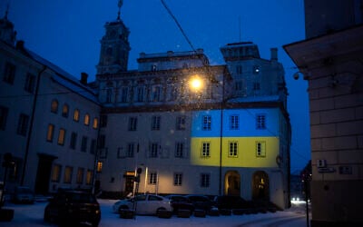 The Vilnius University building is illuminated with the colors of Ukraine to mark the one-year anniversary of Russia's invasion of the country, in Vilnius, Lithuania, February 24, 2023. (AP Photo/Mindaugas Kulbis)