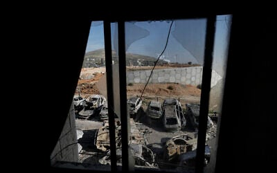 Burned cars are seen through a broken window in the town of Huwara, near the West Bank city of Nablus, February 27, 2023. (AP Photo/Majdi Mohammed)