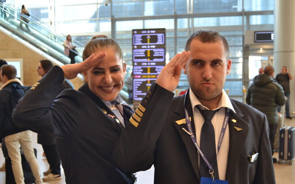 Idan Fishslevich, a 22-year-old with high functioning ASD who was made a flight attendant for one day, together with El Al’s Ambassadors Program director Efrat Raelbrook, after returning to Israel, February 22, 2023. (Tobias Siegal/The Times of Israel)