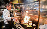 A worker at a restaurant in Tel Aviv, March 3, 2021. (Avshalom Sassoni/Flash90)