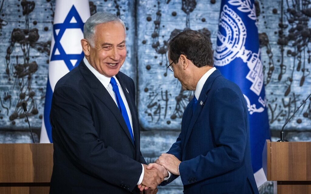 President Isaac Herzog (right) shakes hands with Benjamin Netanyahu after presenting the Likud leader with a mandate to form a new government, at the President's Residence in Jerusalem on November 13, 2022. (Olivier Fitoussi/Flash90) President Isaac Herzog (right) shakes hands with Benjamin Netanyahu after presenting the Likud leader with a mandate to form a new government, at the President's Residence in Jerusalem on November 13, 2022. (Olivier Fitoussi/Flash90)