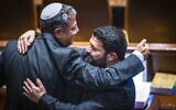 Otzma Yehudit leader Itamar Ben Gvir (L) and MK Almog Cohen embrace at the Knesset in Jerusalem, November 22, 2022. (Olivier Fitoussi/Flash90)