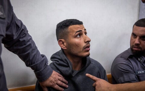 A man, suspected of breaking into an apartment and raping a woman in Gedera, arrives for a court hearing at the Rishon Lezion Magistrate's Court, on February 5, 2023. (Hadas Parush/Flash90)
