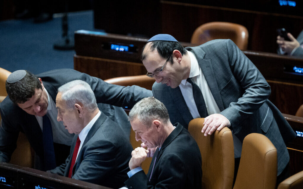 Prime Minister Benjamin Netanyahu, second from left, with Justice Minister Yariv Levin, center, and MK Simcha Rothman, right, during a vote in the Knesset, February 15, 2023. (Yonatan Sindel/Flash90) Prime Minister Benjamin Netanyahu, second from left, with Justice Minister Yariv Levin, center, and MK Simcha Rothman, right, during a vote in the Knesset, February 15, 2023. (Yonatan Sindel/Flash90)
