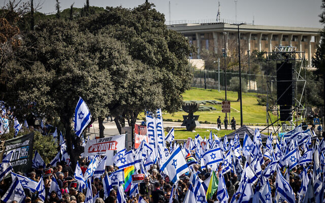 Thousands of protesters wave Israeli flags as they rally against the judicial overhaul outside the Knesset in Jerusalem, on February 20, 2023. (Yonatan Sindel/Flash90) Thousands of protesters wave Israeli flags as they rally against the judicial overhaul outside the Knesset in Jerusalem, on February 20, 2023. (Yonatan Sindel/Flash90)